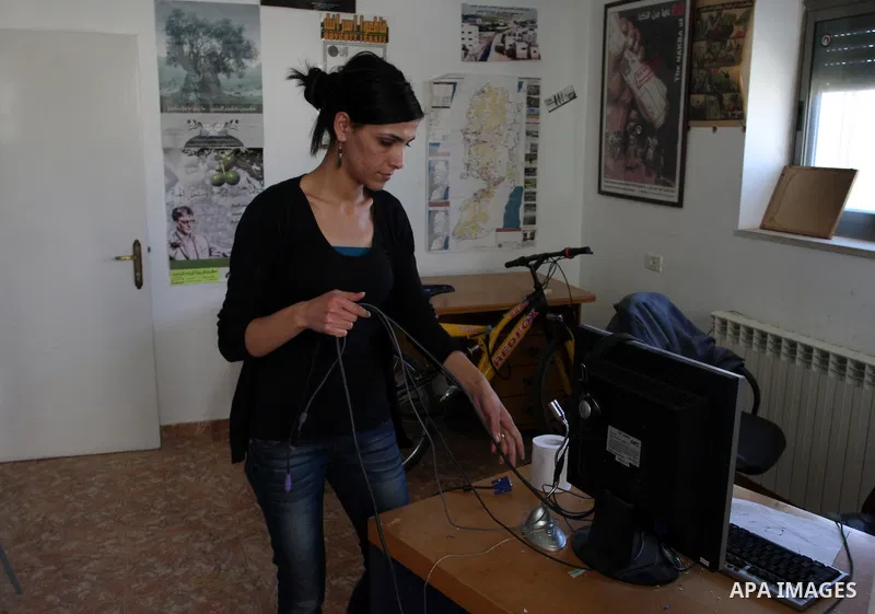 A Palestinian activist shows dismantled computers on May 8, 2012 at the offices of the Stop the Wall Campaign, a grassroots' movement overseeing the stuggle of the popoular committess in the West Bank against the controv...