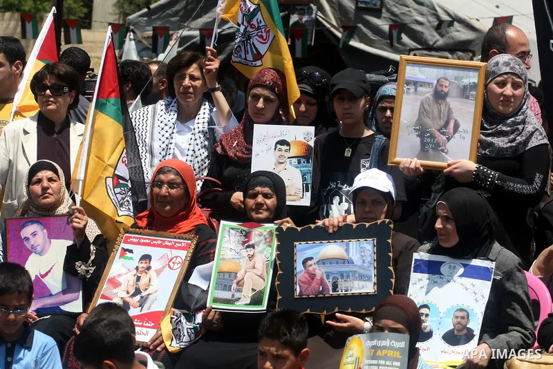 Palestinians participate in a rally supporting Palestinian inmates on hunger strike since mid-April 2012, in the West Bank City of Ramallah, May 8, 2012. A Palestinian rights group said recently that half of about 5,000...