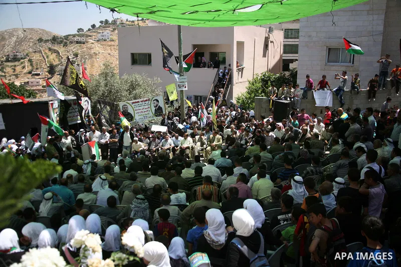 Palestinians hold a sit-in in front of the house of prisoner Thaer Halahle in the West Bank village of Kharas near Hebron, on May 8, 2012. Two Palestinian prisoners Thaer Halahleh, 33, and Bilal Diab, 27, who are on thei...