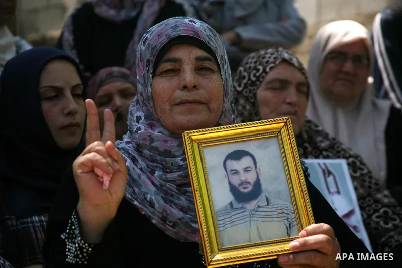 Palestinians hold a sit-in in front of the house of prisoner Thaer Halahle in the West Bank village of Kharas near Hebron, on May 8, 2012. Two Palestinian prisoners Thaer Halahleh, 33, and Bilal Diab, 27, who are on thei...