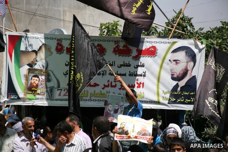 Palestinians hold a sit-in in front of the house of prisoner Thaer Halahle in the West Bank village of Kharas near Hebron, on May 8, 2012. Two Palestinian prisoners Thaer Halahleh, 33, and Bilal Diab, 27, who are on thei...