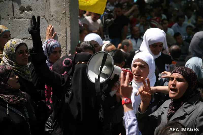 Palestinians hold a sit-in in front of the house of prisoner Thaer Halahle in the West Bank village of Kharas near Hebron, on May 8, 2012. Two Palestinian prisoners Thaer Halahleh, 33, and Bilal Diab, 27, who are on thei...