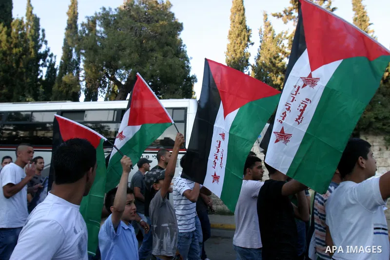 Palestinians carry Palestinian flags during a rally calling for unity and change in east Jerusalem on May 8, 2012. Photo by Mahfouz Abu Turk