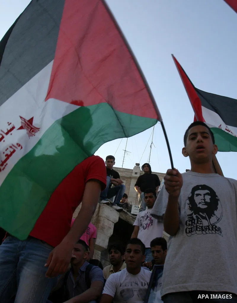 Palestinians carry Palestinian flags during a rally calling for unity and change in east Jerusalem on May 8, 2012. Photo by Mahfouz Abu Turk