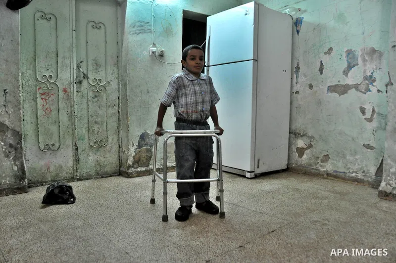 Marwan Abedah (not seen), a 58-year-old Palestinian refugee, and his sons , leave their home in the alleys of the Askar refugee camp in the West Bank City of Nablus, 06 May 2012. The Abedah family, which has three handic...