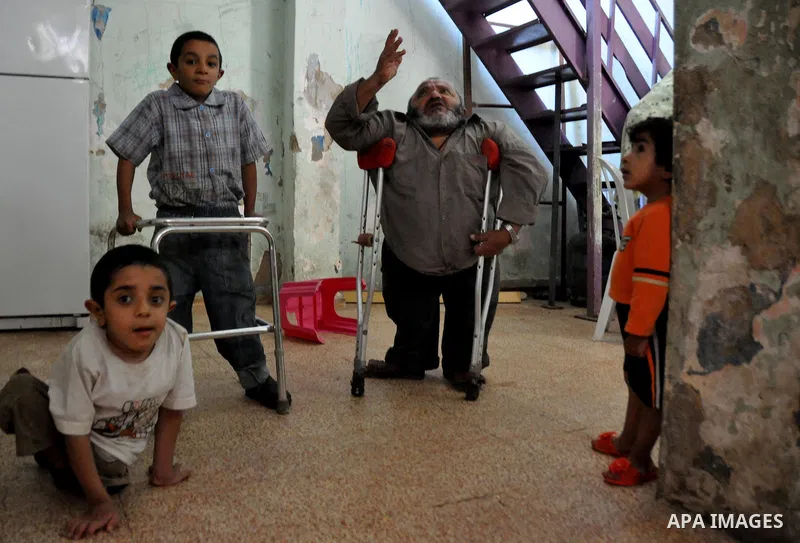 Marwan Abedah, a 58-year-old Palestinian refugee, and his sons , leave their home in the alleys of the Askar refugee camp in the West Bank City of Nablus, 06 May 2012. The Abedah family, which has three handicapped relat...
