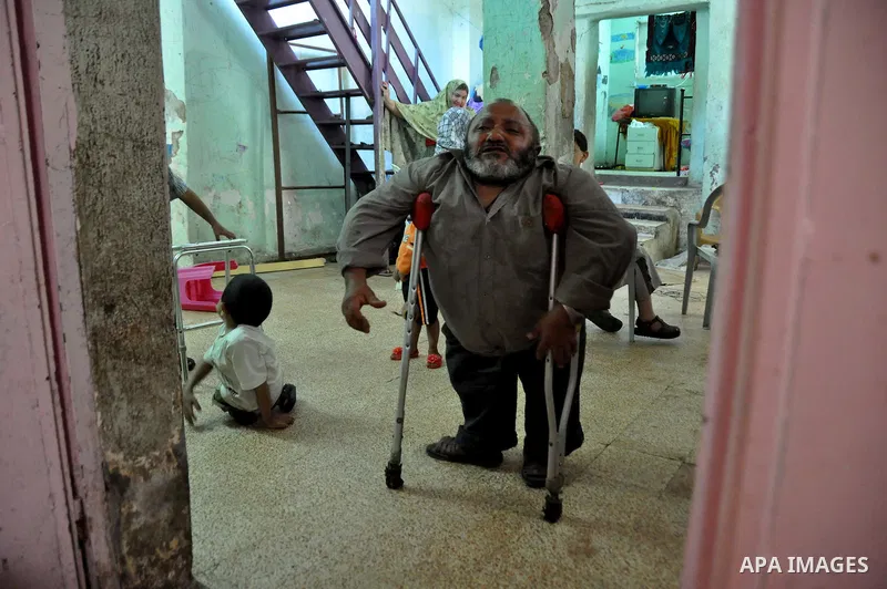 Marwan Abedah, a 58-year-old Palestinian refugee, and his sons , leave their home in the alleys of the Askar refugee camp in the West Bank City of Nablus, 06 May 2012. The Abedah family, which has three handicapped relat...