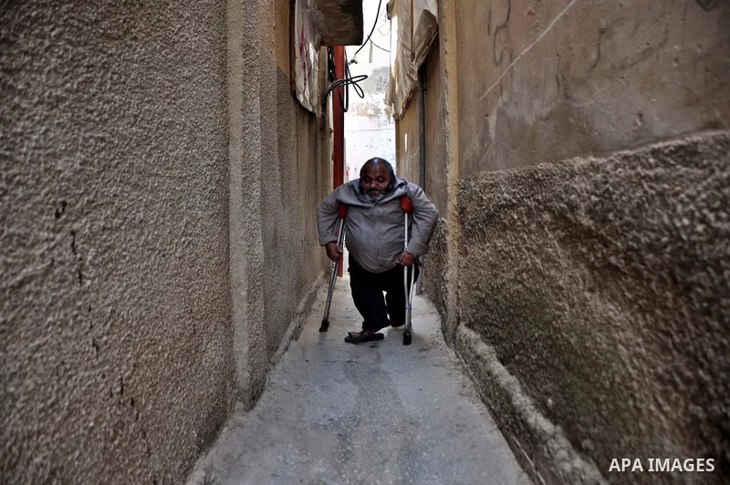 Marwan Abedah, a 58-year-old Palestinian refugee, leave their home in the alleys of the Askar refugee camp in the West Bank City of Nablus, 06 May 2012. The Abedah family, which has three handicapped relatives including...