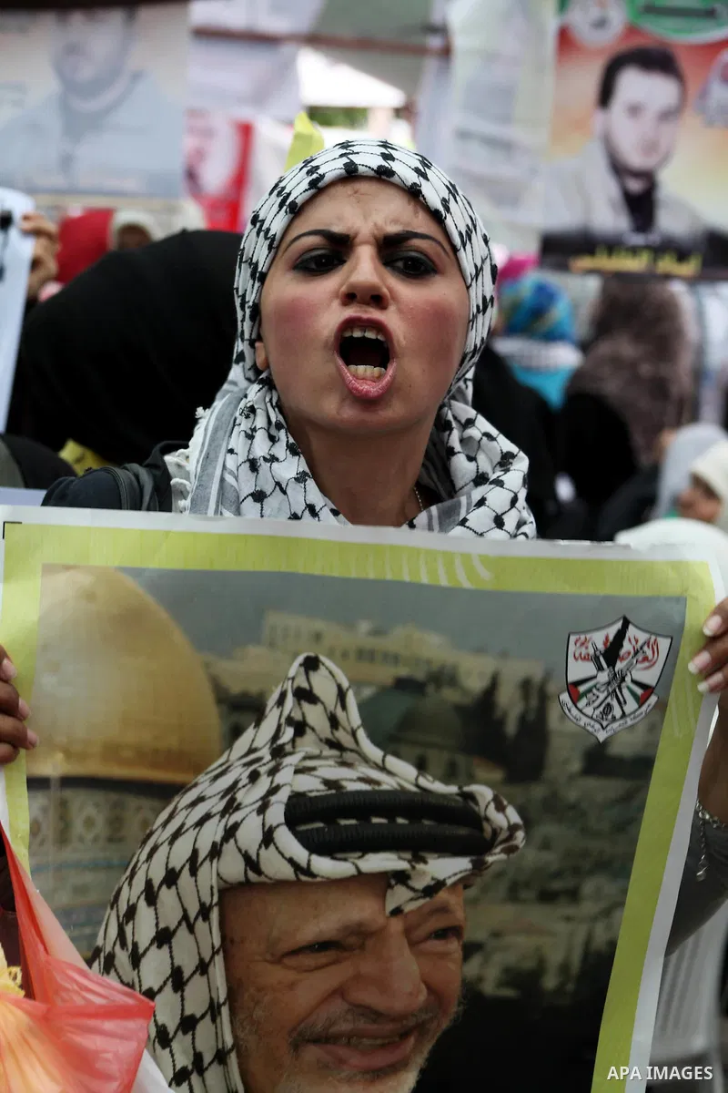 Palestinian woman shouts slogans aduring a demonstration in Gaza City on May 8, 2012 in solidarity with the prisoners. At least 1,550 imprisoned Palestinians are now taking part in a mass hunger strike. Photo by Ashraf A...