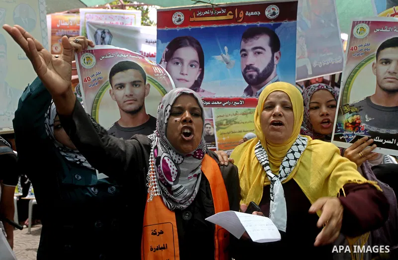 Palestinian women shout slogans aduring a demonstration in Gaza City on May 8, 2012 in solidarity with the prisoners. At least 1,550 imprisoned Palestinians are now taking part in a mass hunger strike. Photo by Ashraf Am...