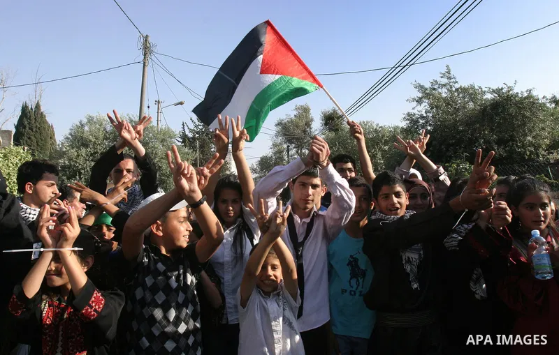 Palestinian protesters hold up portraits of Palestinian prisoners, held in Israeli jails, during a demonstration in front of the Red Cross center, east Jerusalem, on May 9, 2012 in solidarity with the prisoners. At least...