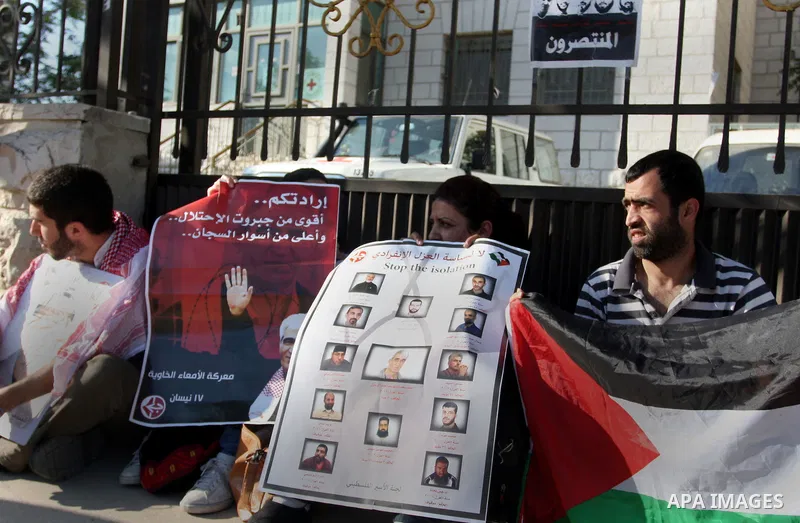 Palestinians participate in a rally supporting Palestinian inmates on hunger strike since mid-April 2012, outside The International Red Cross offices in the West Bank City of Ramallah, May 10, 2012. A Palestinian rights...