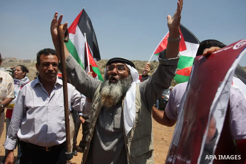 Palestinian protesters take part during a demonstration outside the Ofer Prison close to the West Bank city of Ramallah, in support of Palestinian prisoners on hunger strike in Israeli jails, on May 10, 2012. Israel's pr...