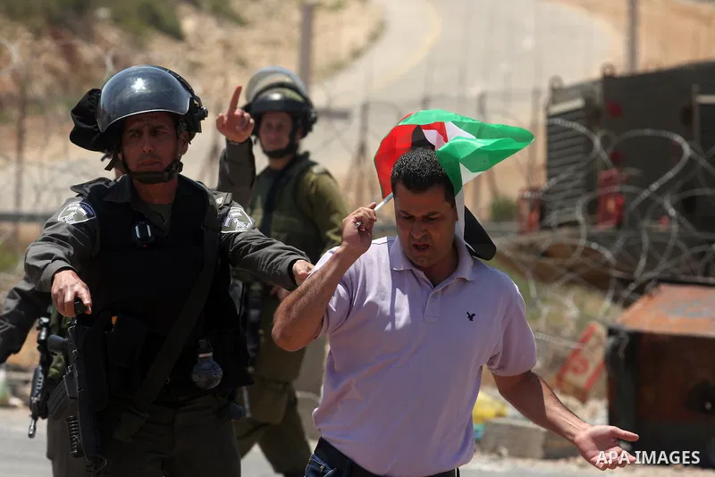 Israeli soldiers arrest a demonstrator outside the Ofer Prison close to the West Bank city of Ramallah, during a demonstration in support of Palestinian prisoners on hunger strike in Israeli jails, on May 10, 2012. Israe...