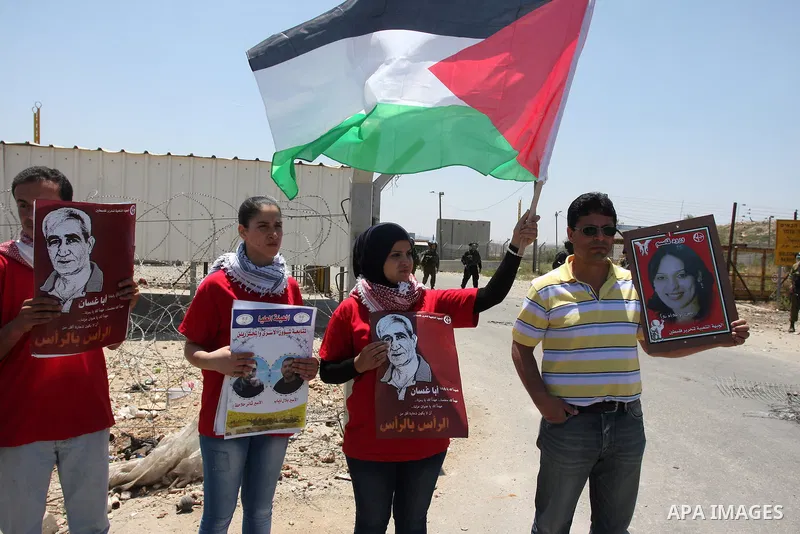 Palestinian protesters take part during a demonstration outside the Ofer Prison close to the West Bank city of Ramallah, in support of Palestinian prisoners on hunger strike in Israeli jails, on May 10, 2012. Israel's pr...