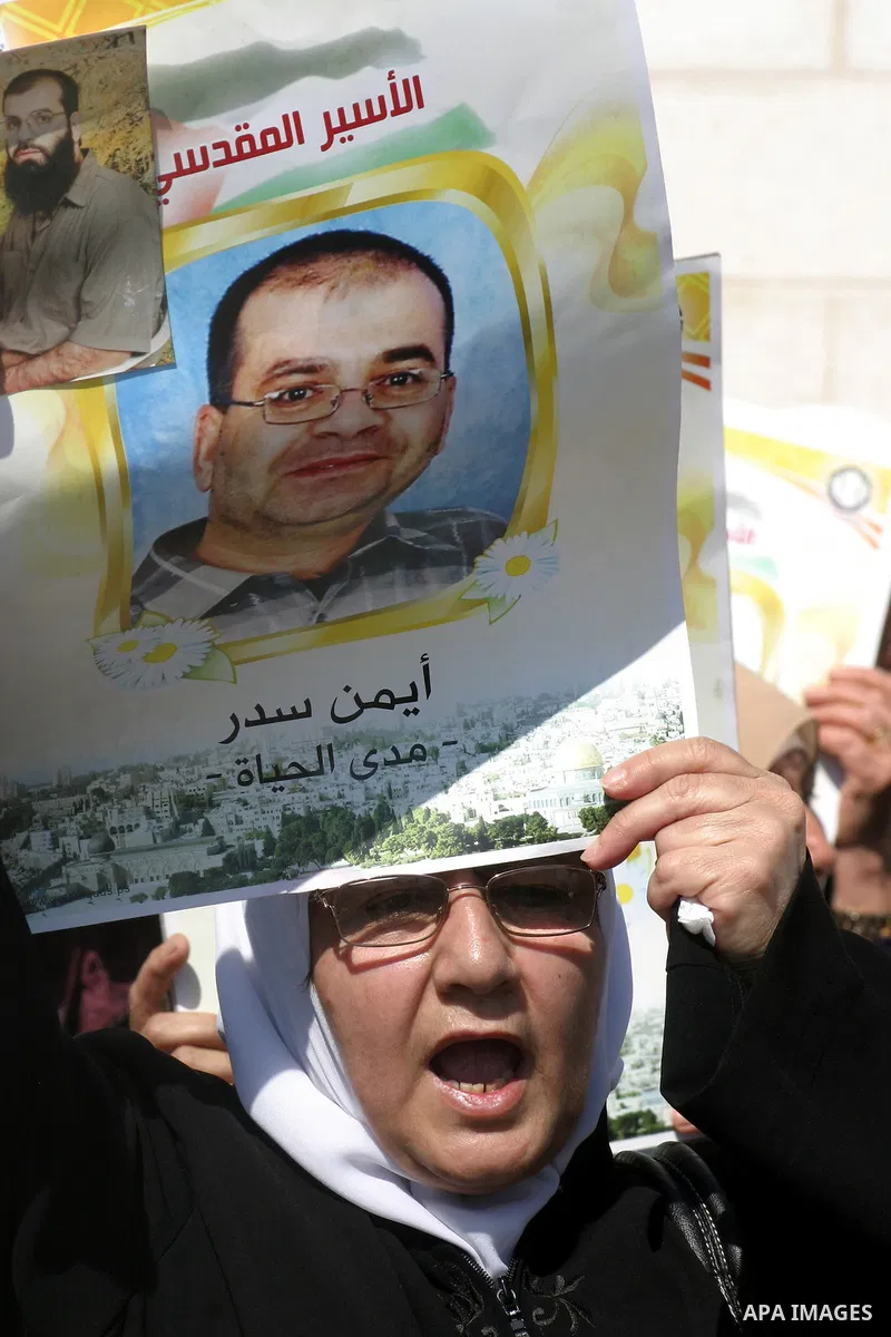 Palestinians hold portraits of their relatives held in Israeli jails during a protest in solidarity with prisoners on hunger strike, outside the European Union Representative Office in East Jerusalem May 10, 2012. Palest...