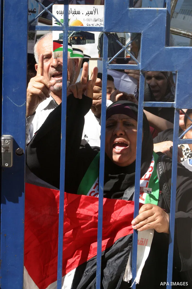 Palestinians hold portraits of their relatives held in Israeli jails during a protest in solidarity with prisoners on hunger strike, outside the European Union Representative Office in East Jerusalem May 10, 2012. Palest...