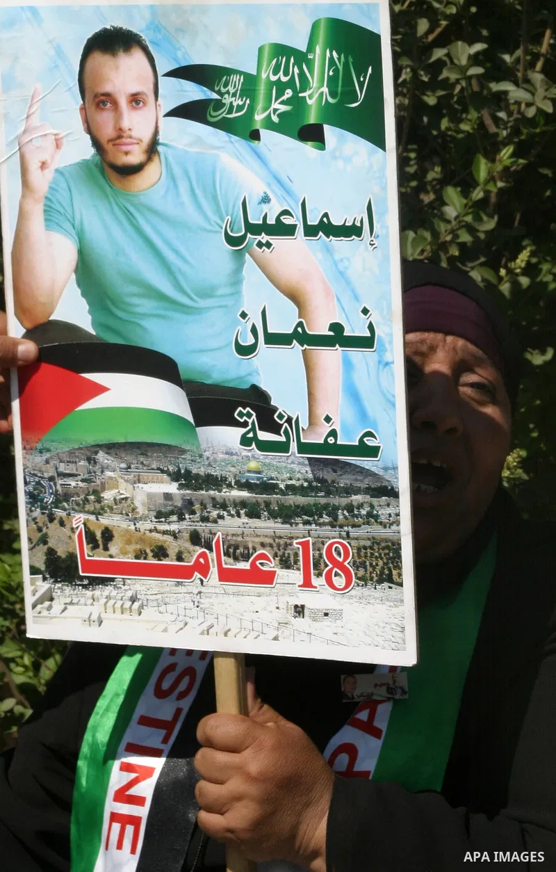 Palestinians hold portraits of their relatives held in Israeli jails during a protest in solidarity with prisoners on hunger strike, outside the European Union Representative Office in East Jerusalem May 10, 2012. Palest...