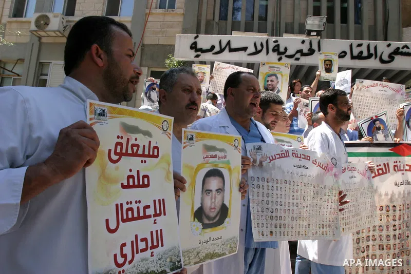 Palestinians hold portraits of their relatives held in Israeli jails during a protest in solidarity with prisoners on hunger strike, outside the European Union Representative Office in East Jerusalem May 10, 2012. Palest...