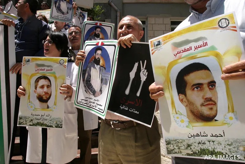 Palestinians hold portraits of their relatives held in Israeli jails during a protest in solidarity with prisoners on hunger strike, outside the European Union Representative Office in East Jerusalem May 10, 2012. Palest...