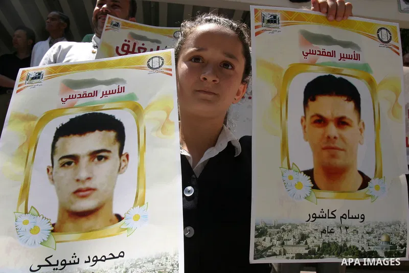 Palestinians hold portraits of their relatives held in Israeli jails during a protest in solidarity with prisoners on hunger strike, outside the European Union Representative Office in East Jerusalem May 10, 2012. Palest...