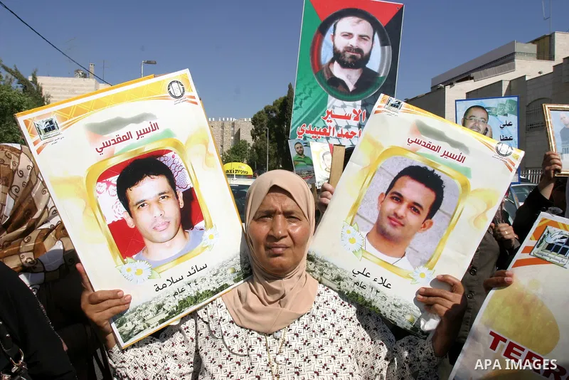 Palestinians hold portraits of their relatives held in Israeli jails during a protest in solidarity with prisoners on hunger strike, outside the European Union Representative Office in East Jerusalem May 10, 2012. Palest...