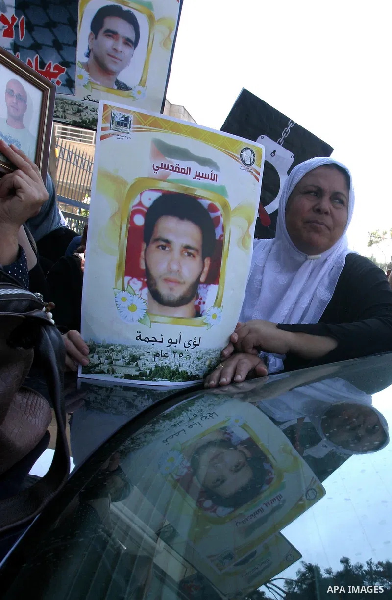 Palestinians hold portraits of their relatives held in Israeli jails during a protest in solidarity with prisoners on hunger strike, outside the European Union Representative Office in East Jerusalem May 10, 2012. Palest...