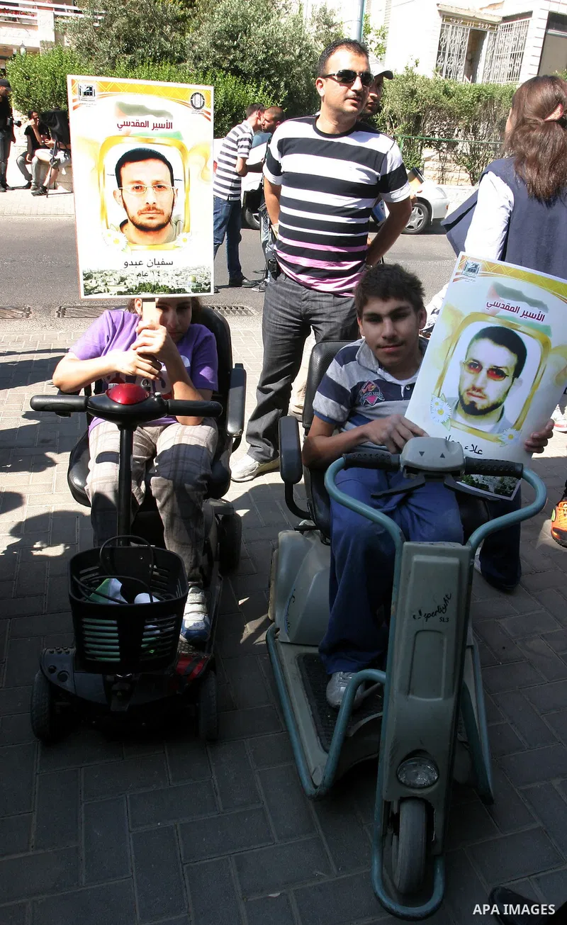 Palestinians hold portraits of their relatives held in Israeli jails during a protest in solidarity with prisoners on hunger strike, outside the European Union Representative Office in East Jerusalem May 10, 2012. Palest...