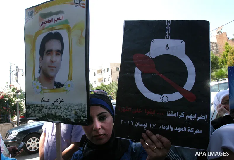 Palestinians hold portraits of their relatives held in Israeli jails during a protest in solidarity with prisoners on hunger strike, outside the European Union Representative Office in East Jerusalem May 10, 2012. Palest...