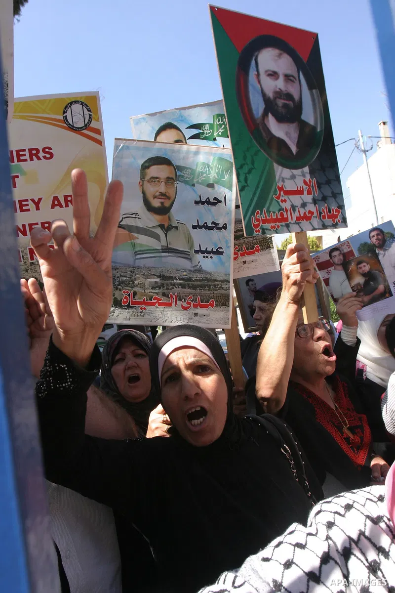 Palestinians hold portraits of their relatives held in Israeli jails during a protest in solidarity with prisoners on hunger strike, outside the European Union Representative Office in East Jerusalem May 10, 2012. Palest...