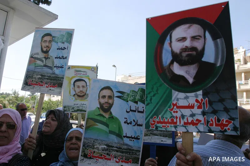 Palestinians hold portraits of their relatives held in Israeli jails during a protest in solidarity with prisoners on hunger strike, outside the European Union Representative Office in East Jerusalem May 10, 2012. Palest...