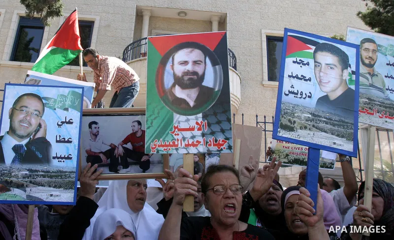 Palestinians hold portraits of their relatives held in Israeli jails during a protest in solidarity with prisoners on hunger strike, outside the European Union Representative Office in East Jerusalem May 10, 2012. Palest...