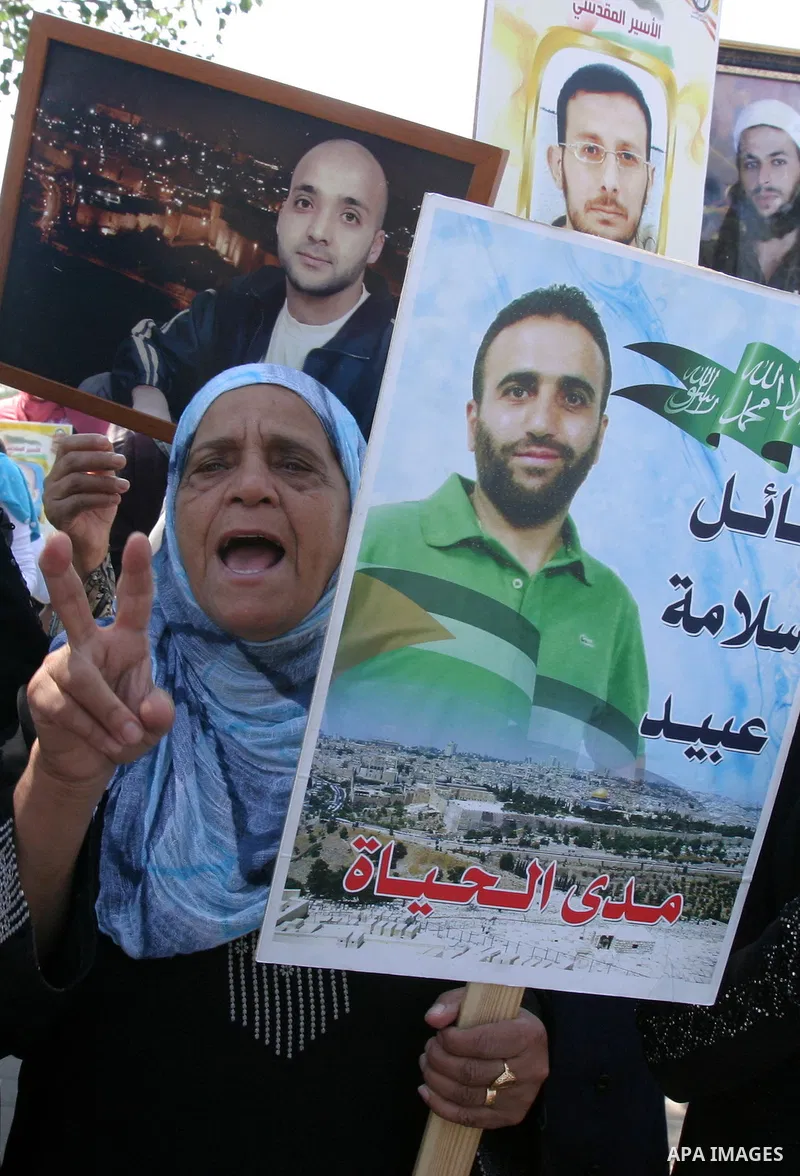 Palestinians hold portraits of their relatives held in Israeli jails during a protest in solidarity with prisoners on hunger strike, outside the European Union Representative Office in East Jerusalem May 10, 2012. Palest...