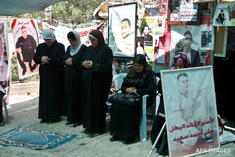Palestinians perform Friday prayers during a sit-in, in the West Bank city of Nablus, May 11, 2012. Palestinians held in prayer outside a tent, in solidarity with prisoners who have been waging a hunger strike in Israeli...