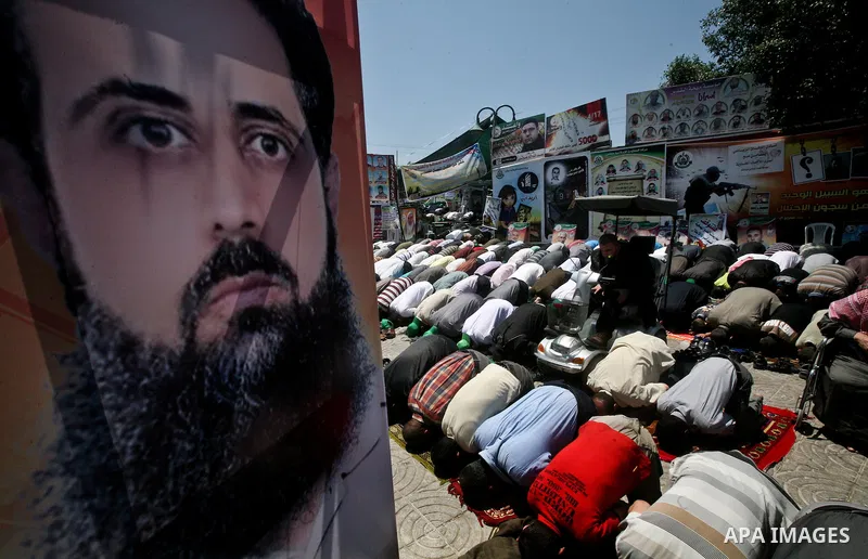 Palestinians attend Friday prayers in Gaza City in support of more than a thousand prisoners who are on an open-ended hunger strike in Israeli jails on May 11, 2012. At least 1,550 Palestinian prisoners are now on hunger...