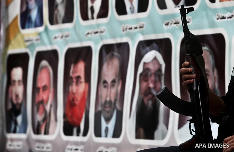 A Hamas policeman stands guard as Palestinians attend Friday prayers in Gaza City in support of more than a thousand prisoners who are on an open-ended hunger strike in Israeli jails on May 11, 2012. At least 1,550 Pales...