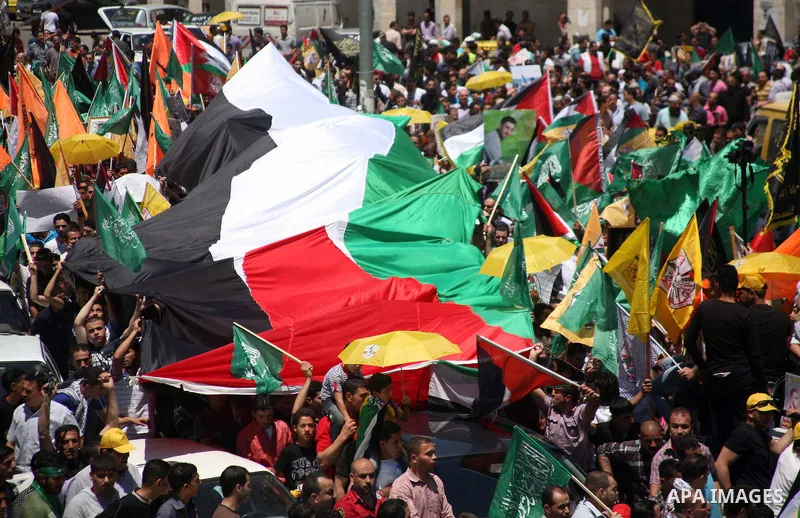 Palestinians participate a demonstration, and hold portraits of prisoners held in Israeli jails, solidarity with prisoners who have been waging a hunger strike in Israeli jails, on May 11, 2012, in the West Bank city of...
