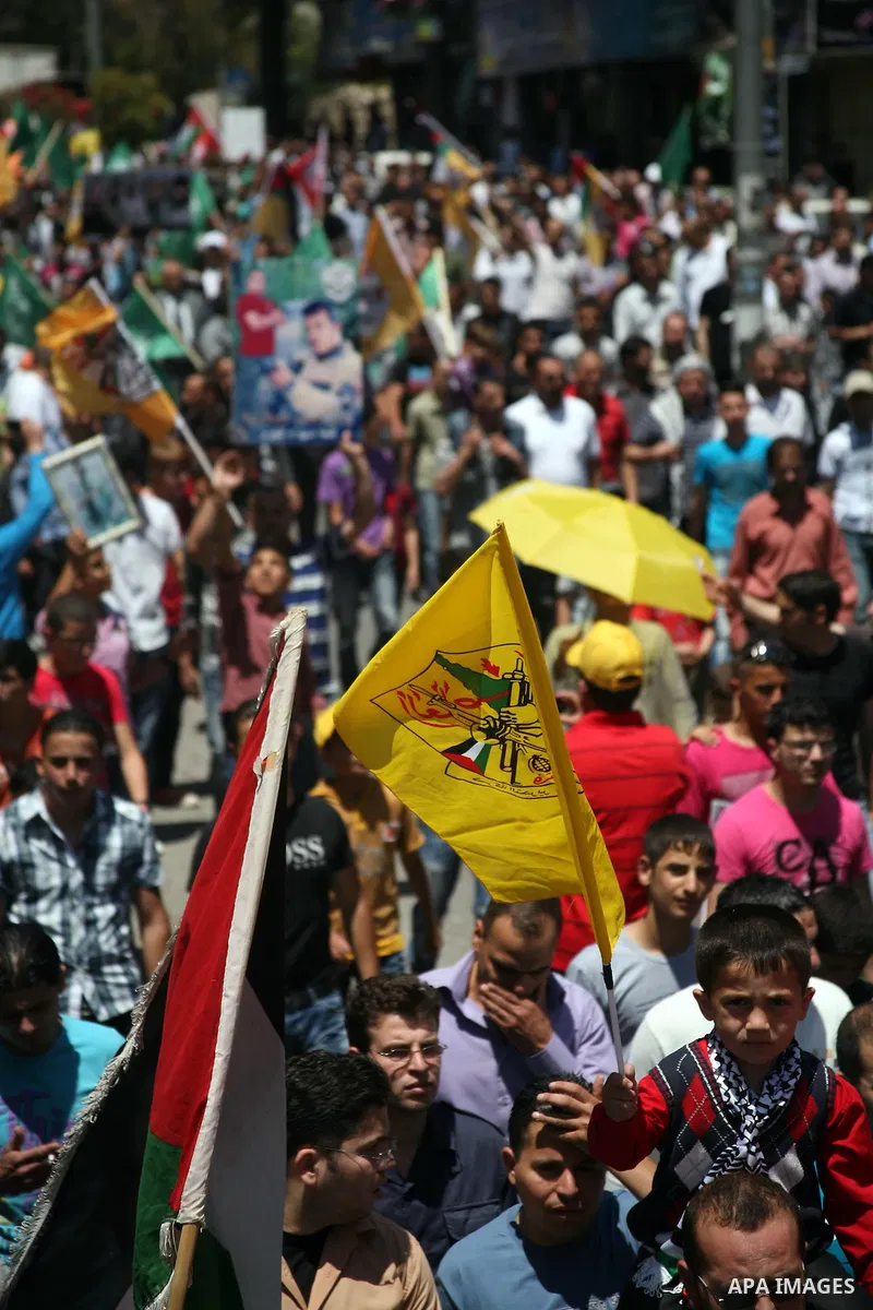 Palestinians participate a demonstration, and hold portraits of prisoners held in Israeli jails, solidarity with prisoners who have been waging a hunger strike in Israeli jails, on May 11, 2012, in the West Bank city of...