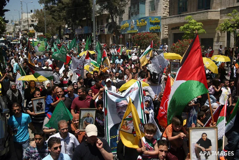 Palestinians participate a demonstration, and hold portraits of prisoners held in Israeli jails, solidarity with prisoners who have been waging a hunger strike in Israeli jails, on May 11, 2012, in the West Bank city of...