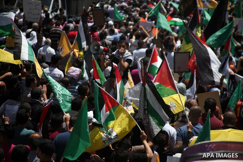 Palestinians participate a demonstration, and hold portraits of prisoners held in Israeli jails, solidarity with prisoners who have been waging a hunger strike in Israeli jails, on May 11, 2012, in the West Bank city of...