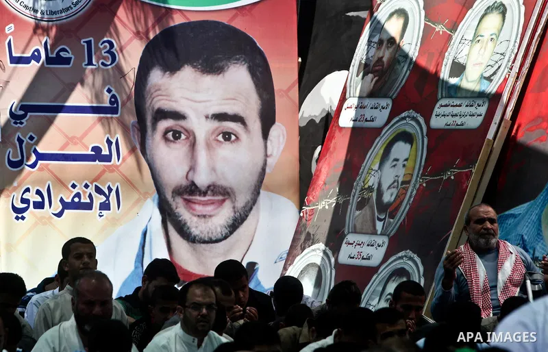 Palestinians attend Friday prayers in Gaza City in support of more than a thousand prisoners who are on an open-ended hunger strike in Israeli jails on May 11, 2012. At least 1,550 Palestinian prisoners are now on hunger...