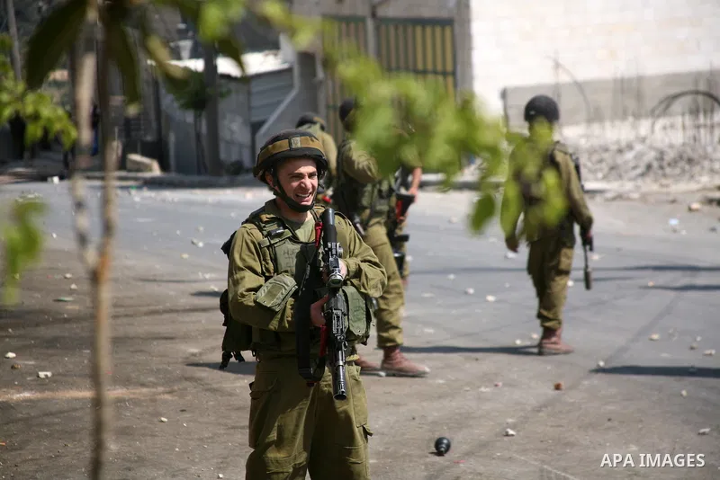 Israeli soldiers fire tear gas at stone throwing Palestinians after clashes broke out during a protest in solidarity with incarcerated Palestinians on hunger strike in Israeli jails on May 11, 2012, in the village of Bei...