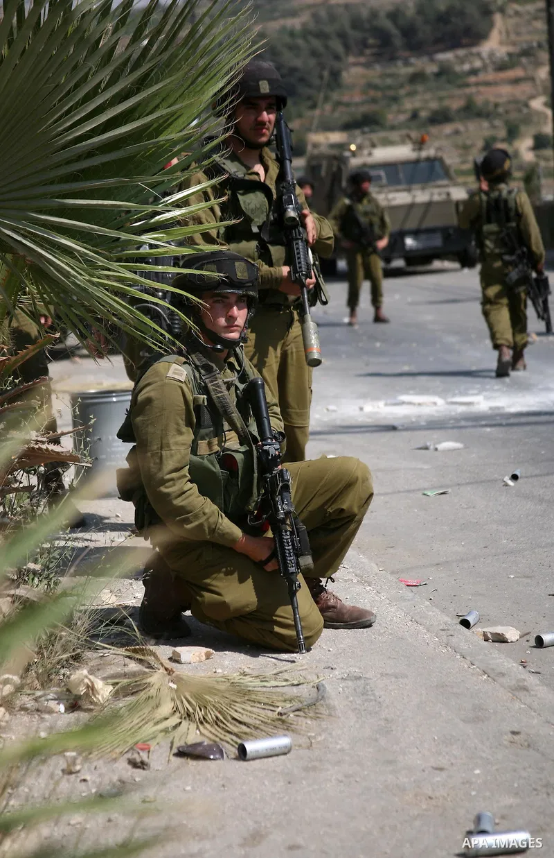Israeli soldiers fire tear gas at stone throwing Palestinians after clashes broke out during a protest in solidarity with incarcerated Palestinians on hunger strike in Israeli jails on May 11, 2012, in the village of Bei...
