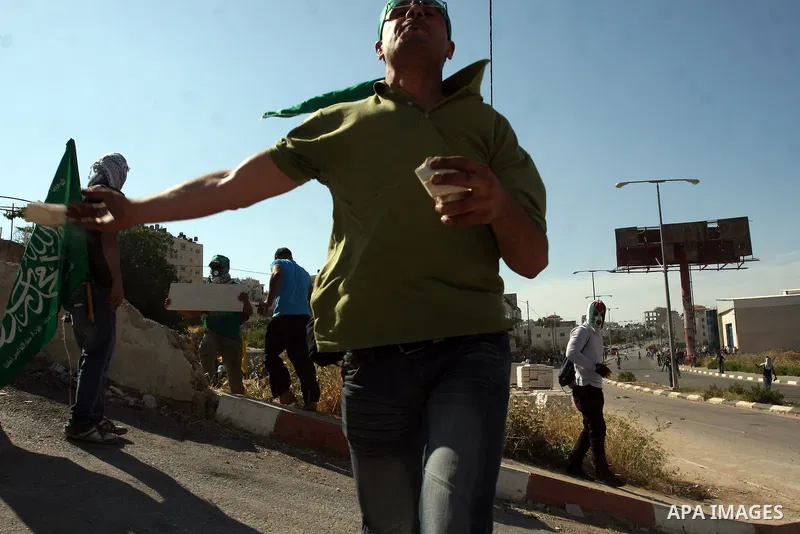 Palestinian stone throwers clash with Israeli soldiers during clashes outside the Ofer Prison near the West Bank city of Ramallah on May 11, 2012 following a demonstration in support of Palestinian prisoners on hunger st...
