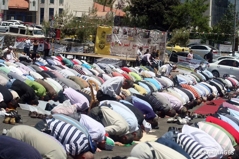 Palestinians perform Friday prayers during a sit-in, in the West Bank city of Ramallah, May 11, 2012. Palestinians held in prayer outside a tent, in solidarity with prisoners who have been waging a hunger strike in Israe...