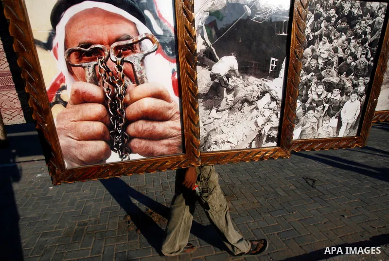 Palestinian old man portrait are seen during a Hamas rally ahead of Nakba, in Rafah refugee camp, Gaza City, 11 May 2012. Palestinians mark the 64rd anniversary of 'Nakba', or catastrophe, in reference to the creation of...