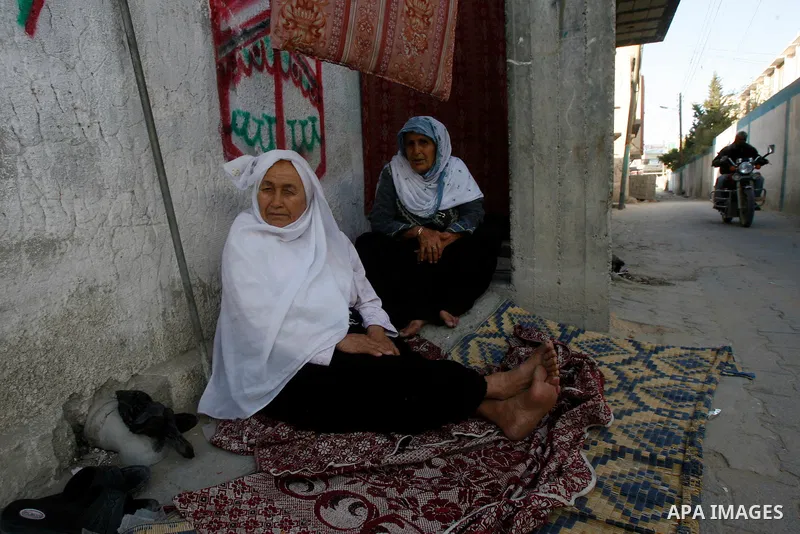 Palestinian old women are seen in front of their house, during a Hamas rally ahead of Nakba, in Rafah refugee camp, Gaza City, 11 May 2012. Palestinians mark the 64rd anniversary of 'Nakba', or catastrophe, in reference...