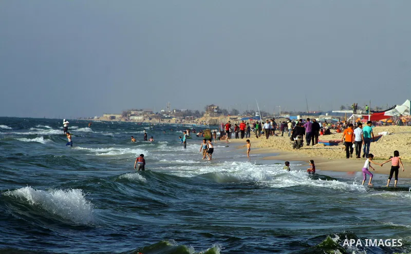 Palestinians enjoy a day on the beach of Khan Yunis, south of the Gaza Strip, on May 12, 2012. Photo by Ashraf Amra