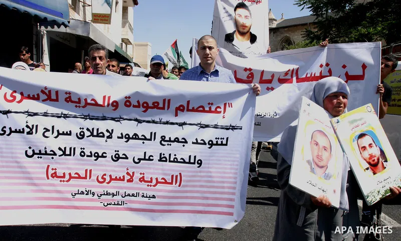 Palestinians hold portraits of relatives held in Israeli jails during a protest on the compound known to Muslims as Noble Sanctuary and to Jews as Temple Mount in Jerusalem's Old City, to show solidarity with prisoners o...