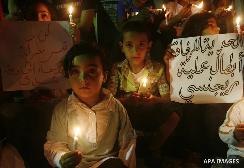 Palestinian children light candles, during a rally outside a tent solidarity with prisoners who have been waging a hunger strike in Israeli jails, in Gaza City May 11, 2012. A hunger strike by Palestinian prisoners again...